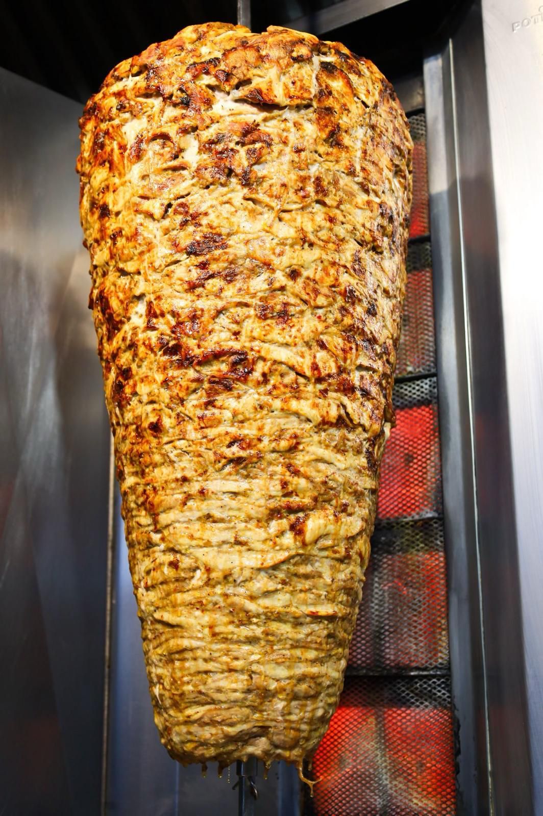 Shawarma being sliced fresh off the spit